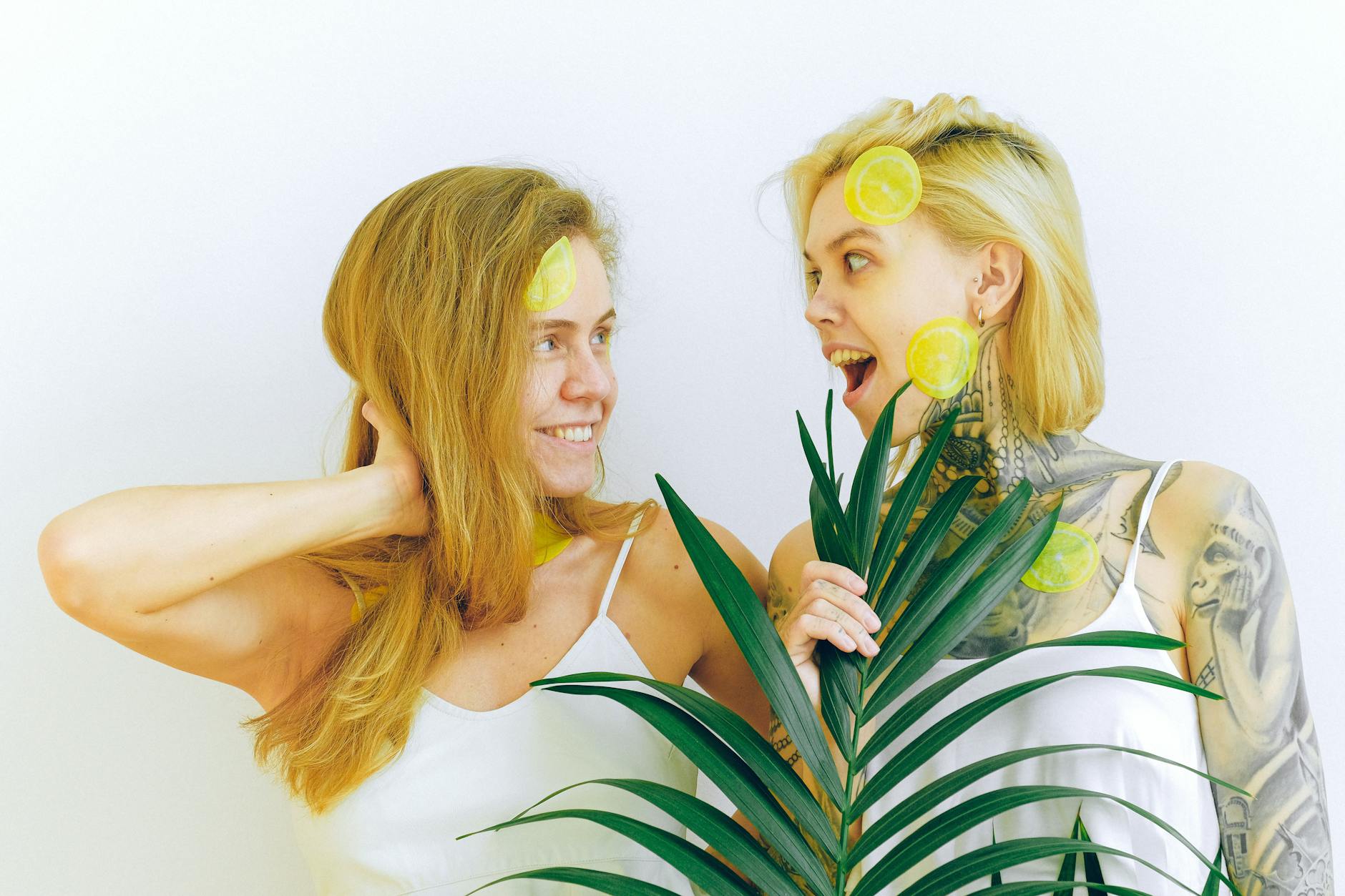Two women smiling with lemons, expressing joy and connection
