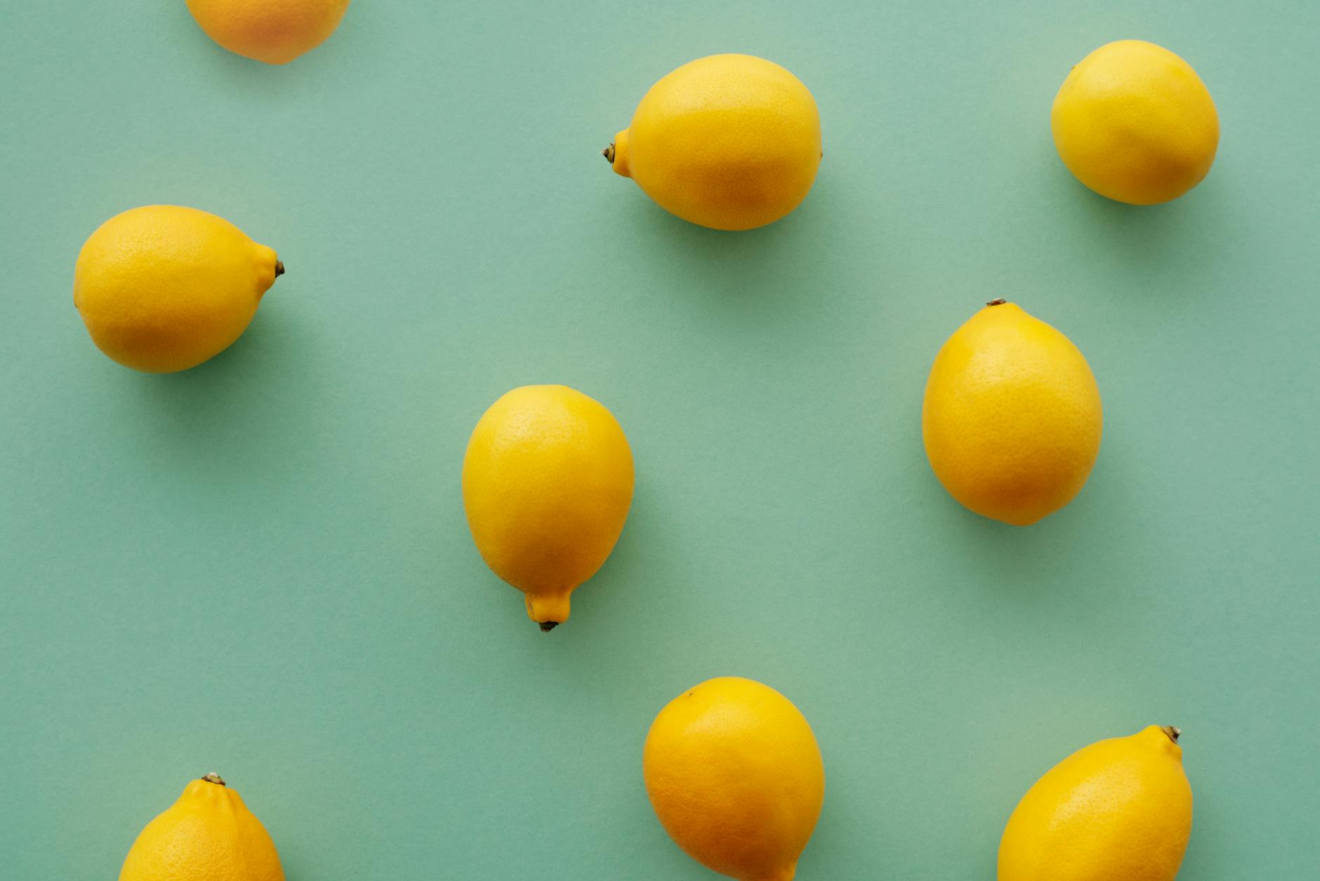 Bright yellow lemons on a pastel background, symbolizing fresh sensation and renewed pleasure