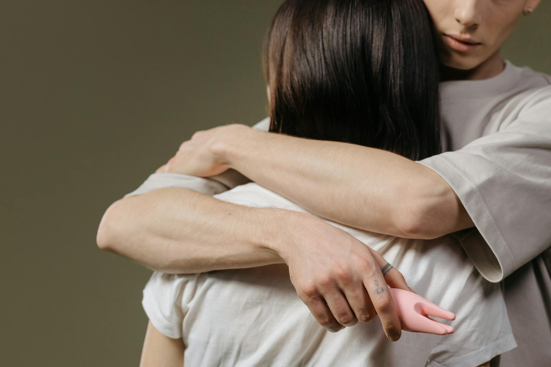 A couple embracing with genuine emotional closeness and vulnerability