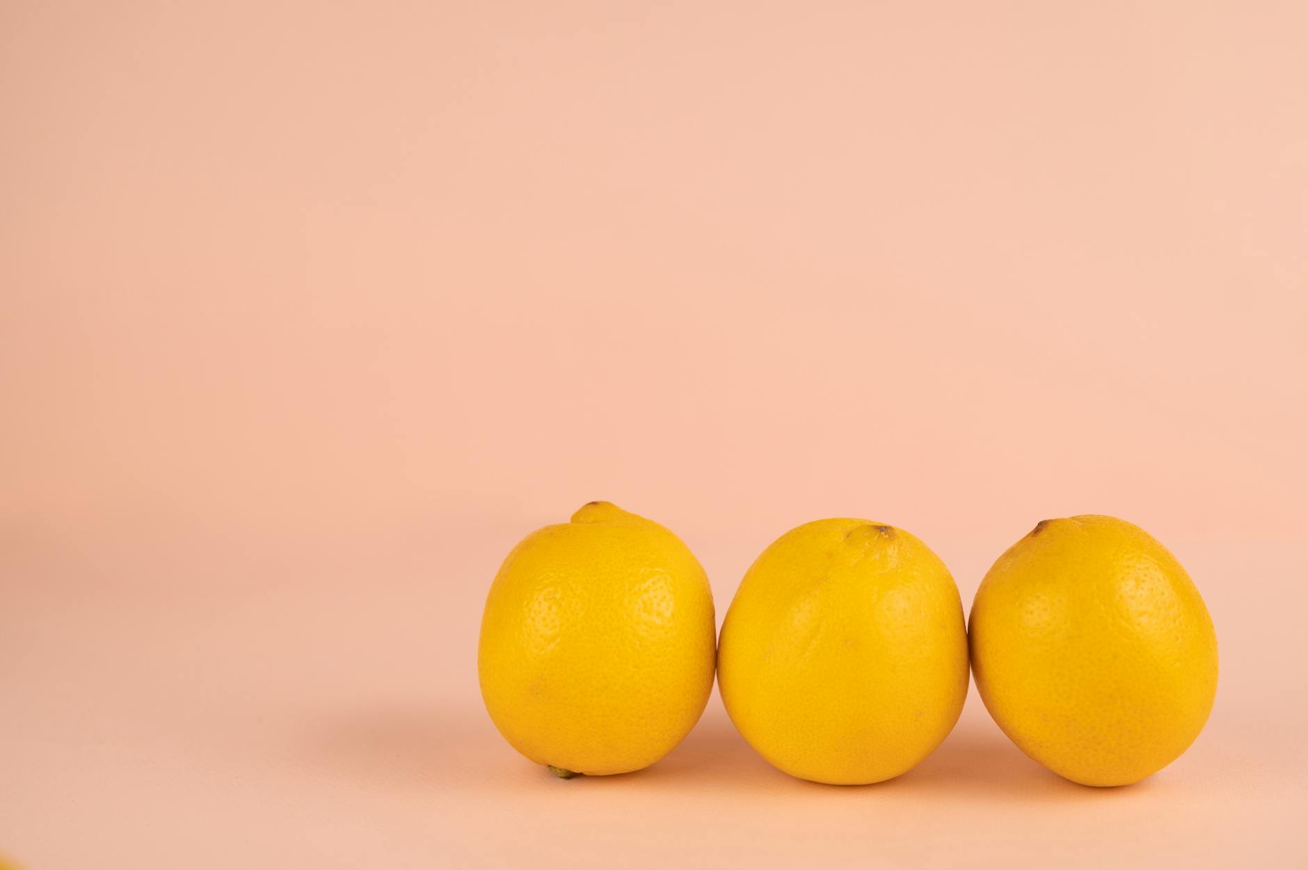 Bright ripe lemons arranged on pastel background, symbolizing healing and renewal